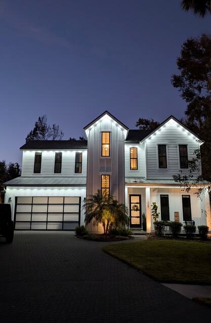 Home with pink and purple permanent lights along the roofline