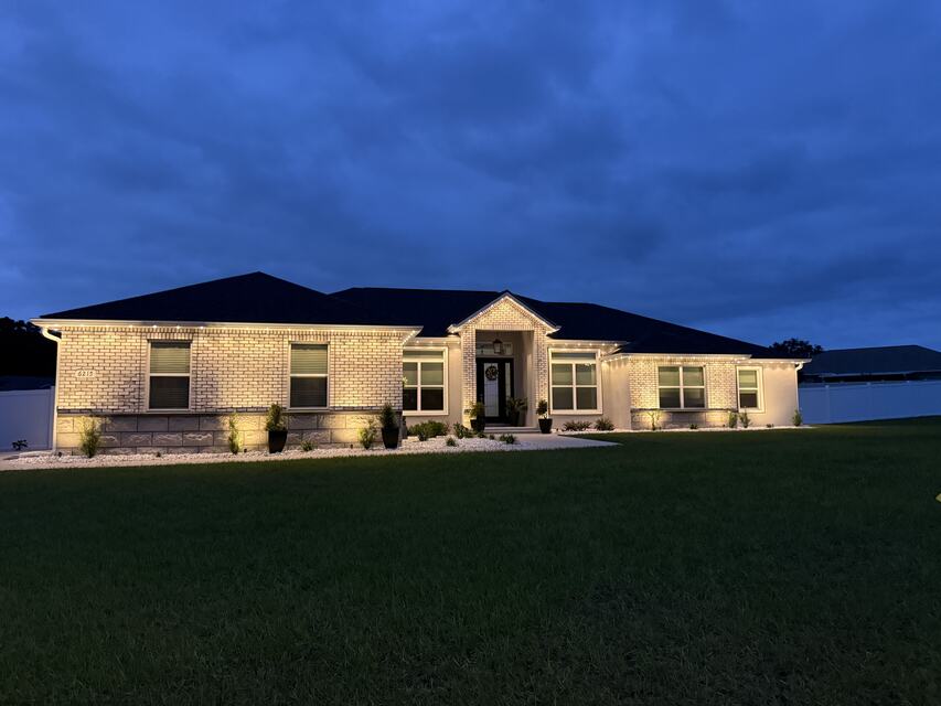 Single-story home at dusk with white roofline lights